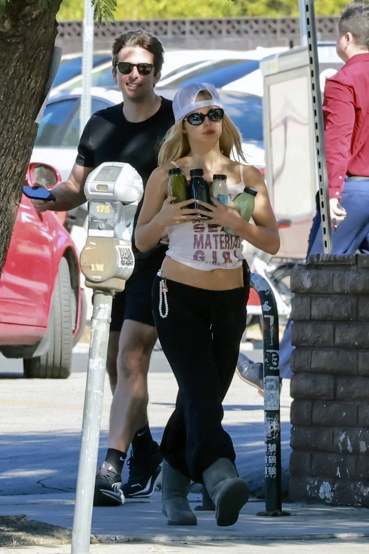 Addison Rae flashes her toned tummy in a crop top and sweatpants while making a juice run with a friend in Los Feliz, California