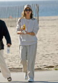 Jessica Alba looks casually stylish in a cream sweater while stopping at a beachside food cart in Los Angeles