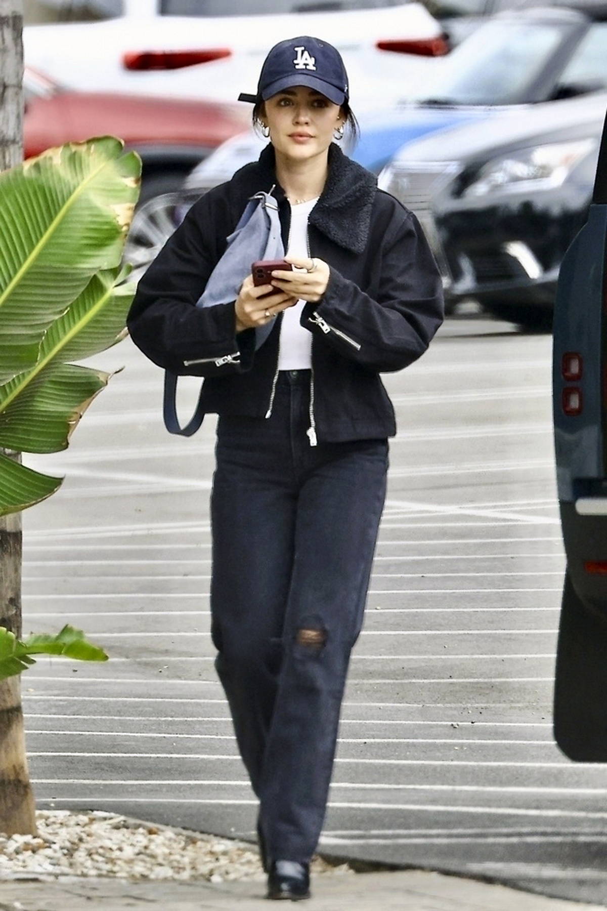 Lucy Hale dons a black jacket with matching denim while making a coffee run with a friend in Studio City, California