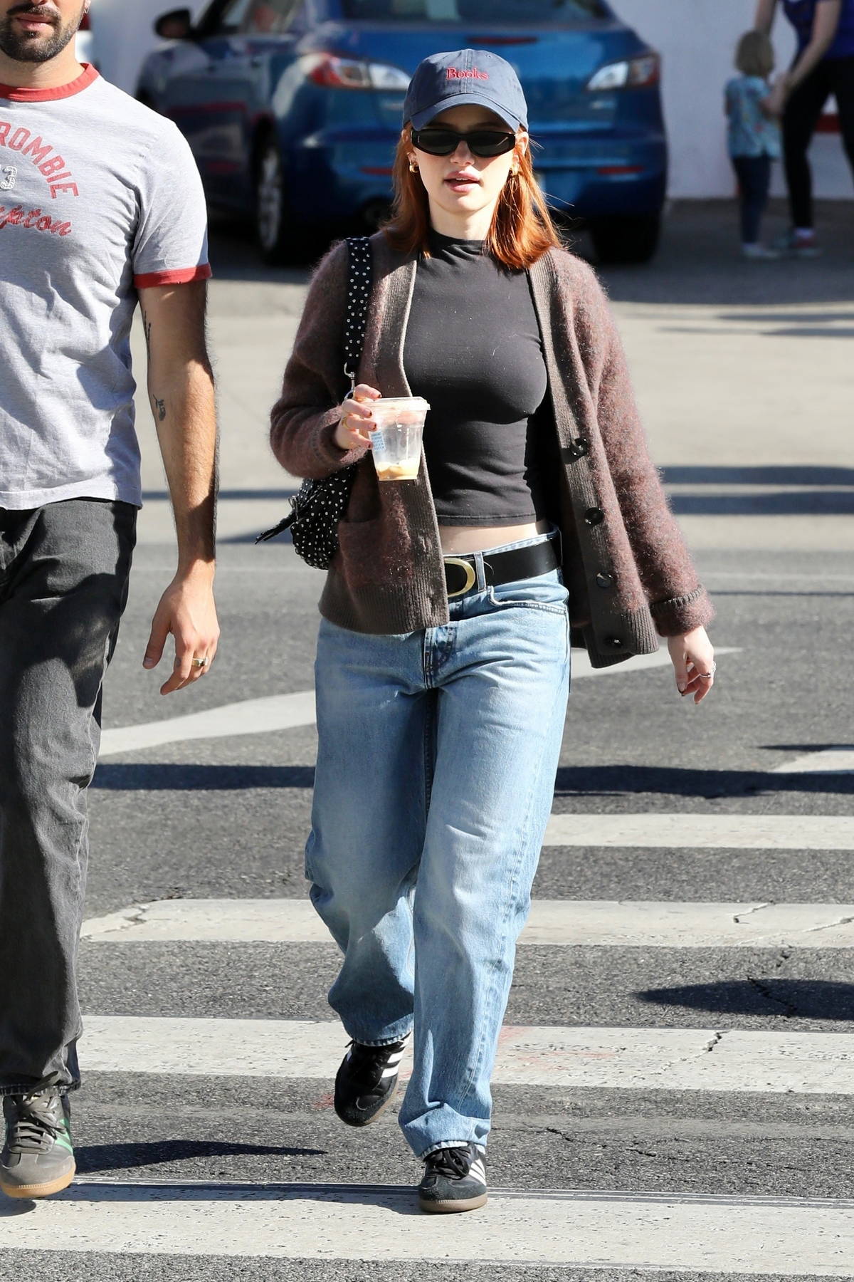 Madelaine Petsch cuts a casual figure in a black top, cardigan and jeans during a trip to the Farmer's Market in Studio City, California