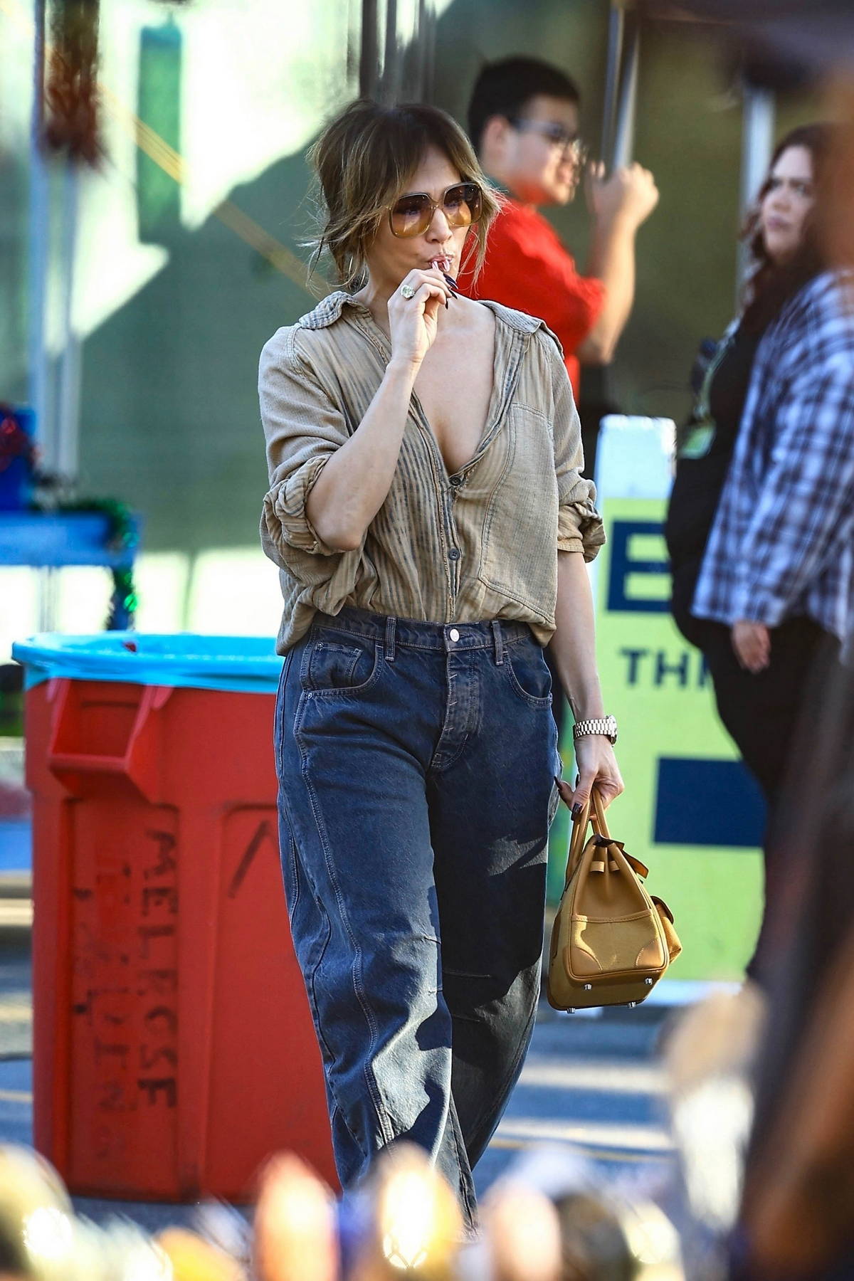 Jennifer Lopez rocks a beige shirt and blue jeans while out shopping with her daughter in West Hollywood, California