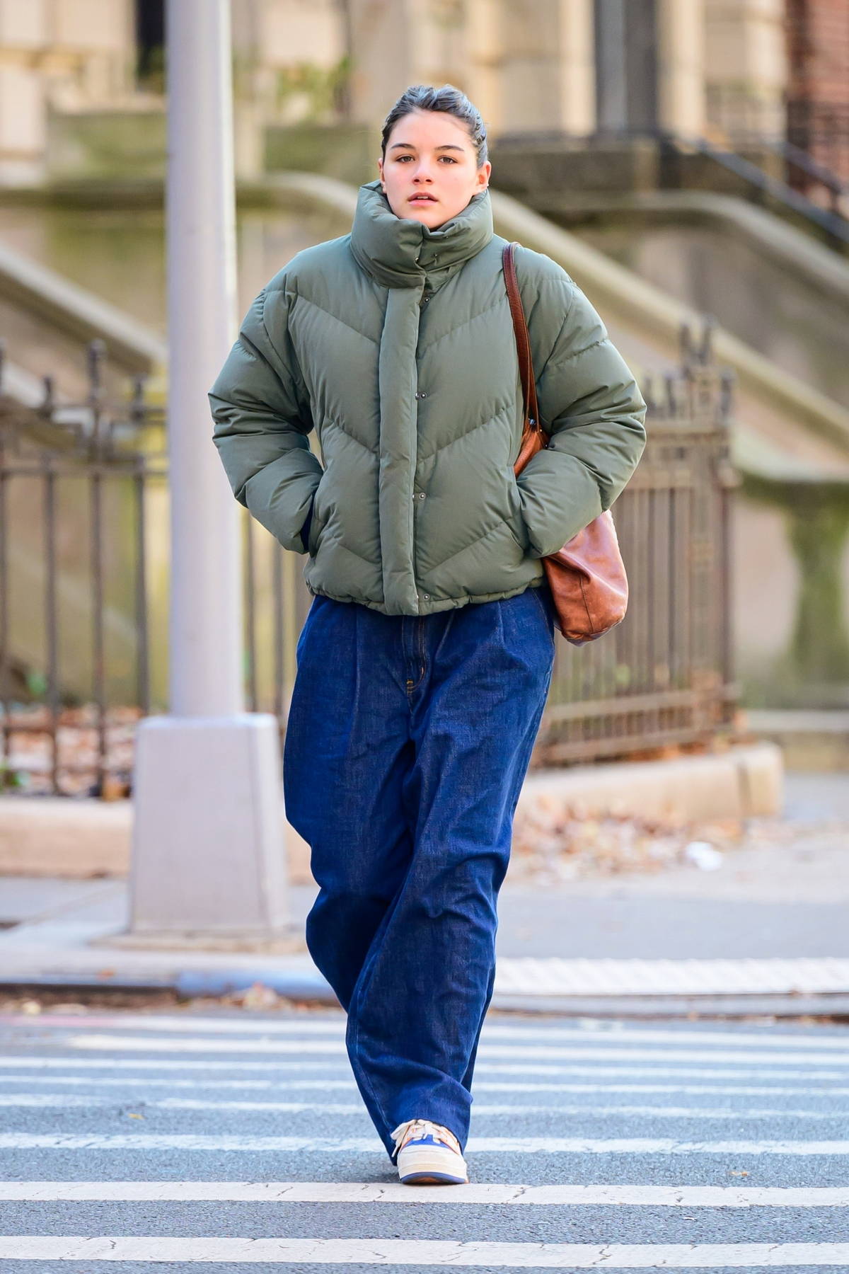 Suri Cruise stays cozy in a green puffer jacket as she steps out on a chilly day in New York City